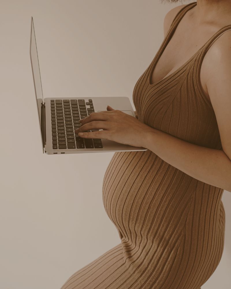 Pregnant woman using laptop for online childbirth education
